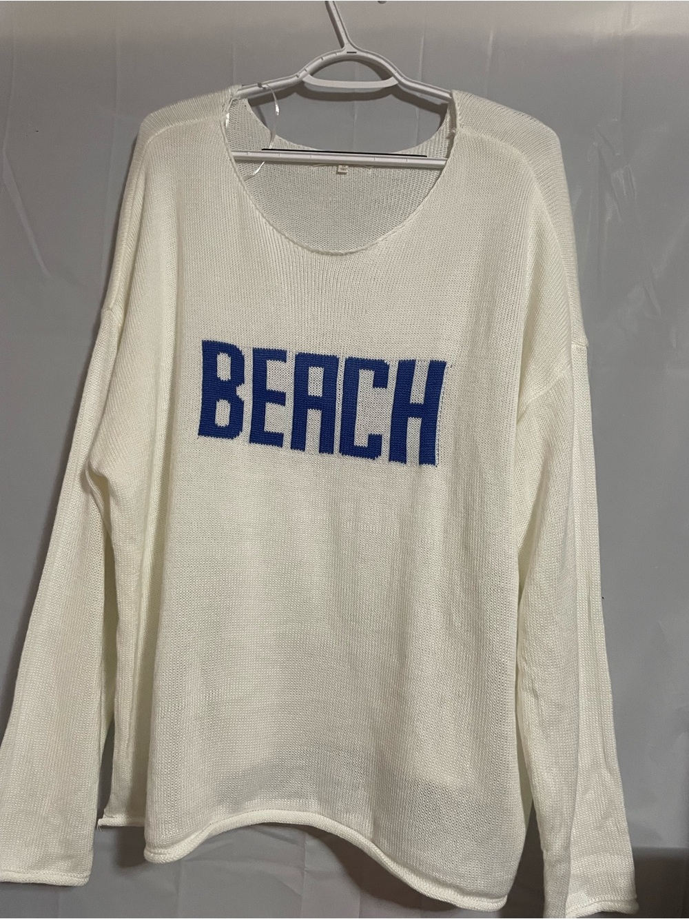 Off-the-Shoulder Cream Sweater with Blue BEACH Graphic